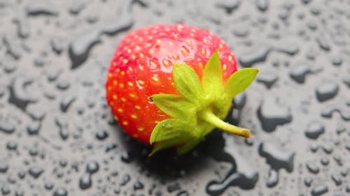 Strawberry Covered with Water Droplets are Spinning