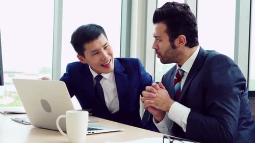 Two Business People Talk Project Strategy at Office