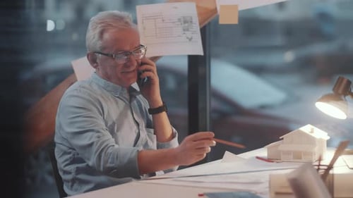 Senior Architect Talking on Phone at Workplace in the Office