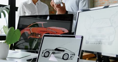 Car Designers Discussing Model in Modern Workplace