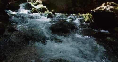 Water is Flowing Over the Rocks on Mountain River or Stream