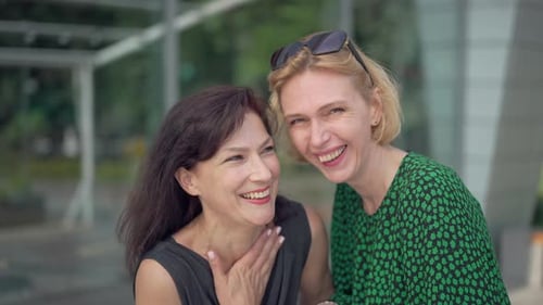 Two Cheerful Laughing Adult Women Looking at Camera Talking in Slow Motion