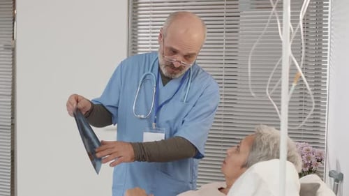 Doctor Discussing X-ray Pic with Aged Patient