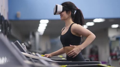 Woman Using VR Headset While Exercising on Treadmill