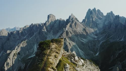 Women Staying on Cliff Edge in Front of Cadini Di Misurina Mountains Group in Dolomites Italy