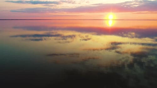 Aerial View of a Calm Clean Lake with a Mirror Surface Reflects the Sun