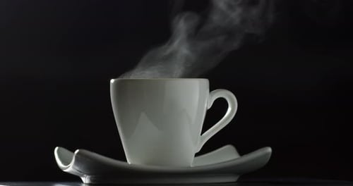 White Cup with Steam on Black Background