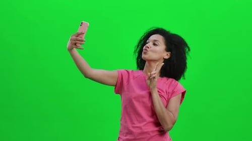 Woman Posing for Selfie on Green Screen