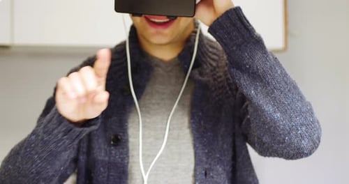Man using virtual reality headset at home