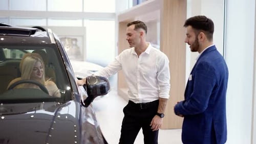Blonde Female Testing Buying Car From Inside During Visit Auto Dealership
