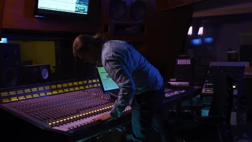 Male sound engineer working at a mixing desk