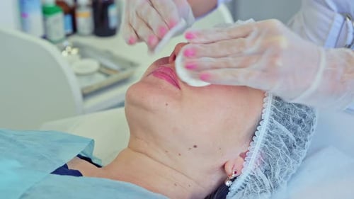 Cosmetologist Performs the Procedure of Cleansing and Moisturizing the Skin