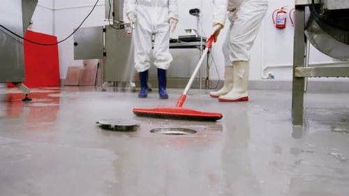 Butchers cleaning floor