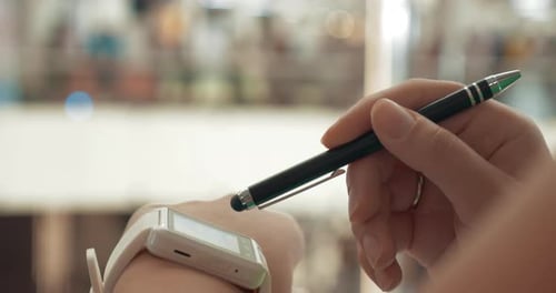 Woman using smartwatch in city street