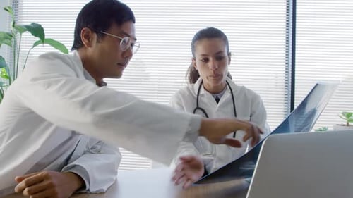 Medical Team Analyzing X-Ray Image in Clinic