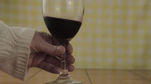 Hand Swirling a Glass of Red Wine