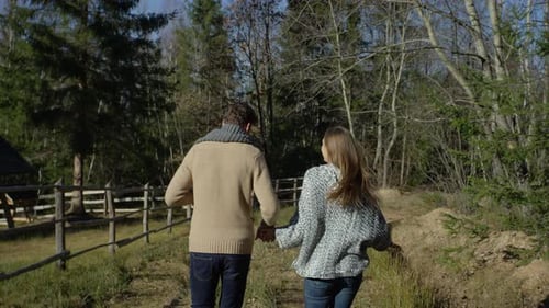 Couple Runs Hand-in-Hand in Rural Setting