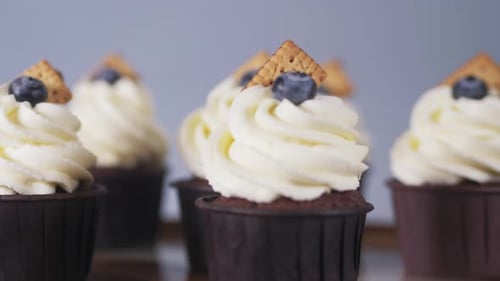 Delicious Cupcakes Topped with Frosting and Blueberries