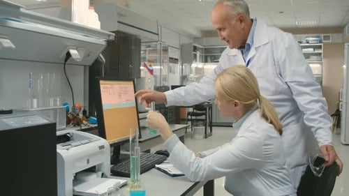 Scientists Discussing Experiment in Bright Laboratory