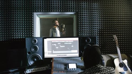 Male Singer Recording Song in Studio