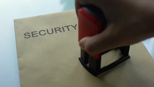 Security Report Classified, Stamping Seal on Folder With Important Documents