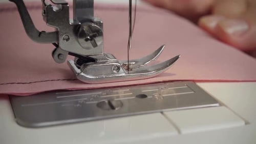 Sewing Machine Needle Stitching Pink Fabric Close Up