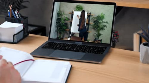 Man at Home Office Study Online Course Laptop Writes in Notebook Listen Teacher