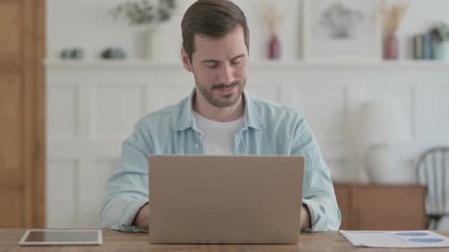 Young Adult Man Working At Home With Neck Pain