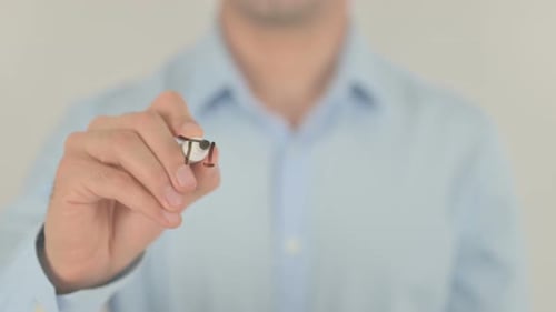 Man Writing Time to Sell on Clear Surface
