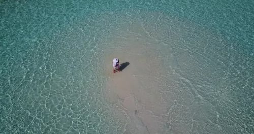 Young boy and girl on honeymoon vacation have fun on beach on summer white sandy background