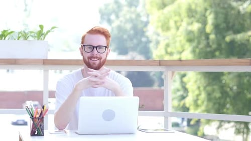 Smiling Man Sitting in Balcony of Office, Outdoor