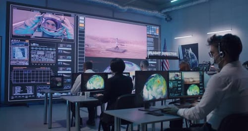 Team Watching Rocket Launch in Office