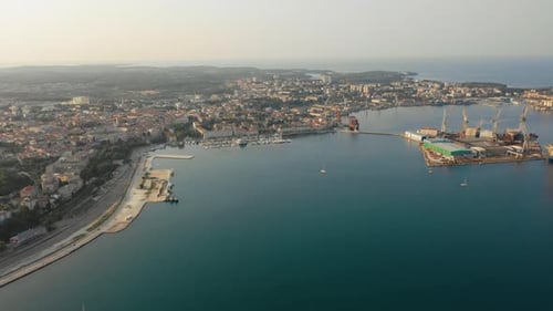 Aerial View of Coastal City and Bustling Harbor