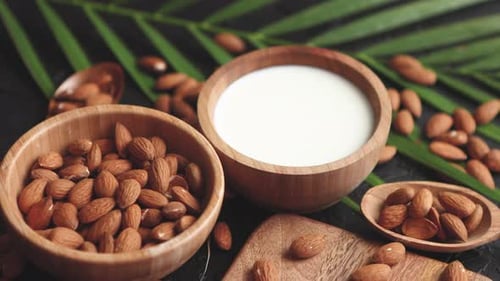 Close Up of Almonds in Wooden Bowl and Almond Milk