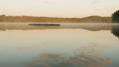 Morning Fog Over the Lake Next To the Autumn Forest