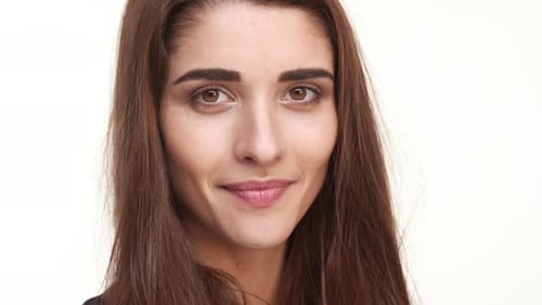 Close Up Footage of Attractive Caucasian Female with Long Dark Hair Winking Flirting Smiling on