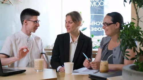 Business People Having Meeting at Coffee Shop