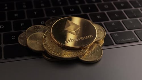 Gold Cryptocurrency Coins on Laptop Keyboard Close-Up