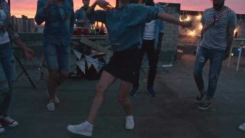 Friends Dance at Rooftop Party During Sunset