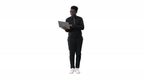 Young Adult Using Laptop on White Backdrop