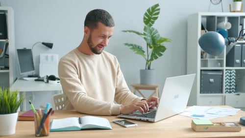 Excited Entrepreneur Feeling Happy Rubbing Hands Smiling Using Laptop in Office