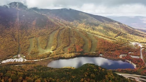 Picturesque Valley Surrounded with Dense Autumn Forest and Mountains