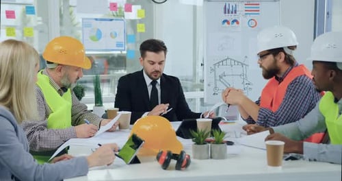 Construction Team Meeting in Bright Modern Office