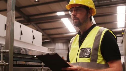 Engineer maintaining record in clipboard