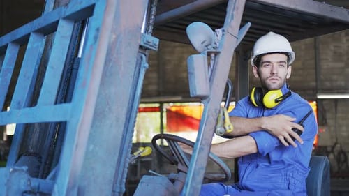 Concentrated forklift caucasian driver operating machine