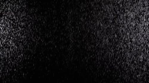 Heavy Rain Falling Against Black Backdrop