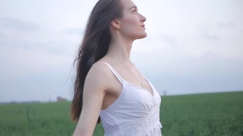 spring fashion portrait of a beautiful happy young woman in white dress with long brown hair walk th