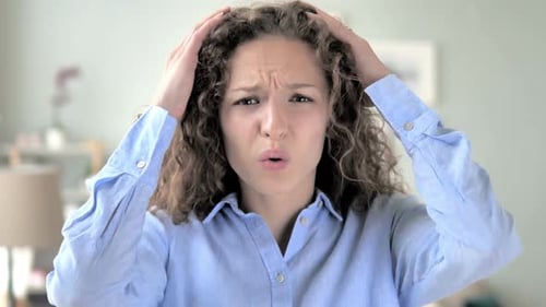 Curly Hair Woman Upset by Loss while Working in Office