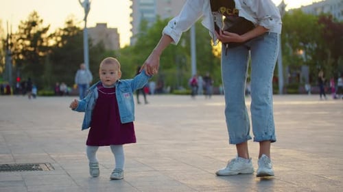 Baby Learning to Walk Toddler Taking First Steps with Mother Helping Infant Teaching Child at
