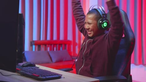 Enthusiastic Young Adult Playing Video Games at Home